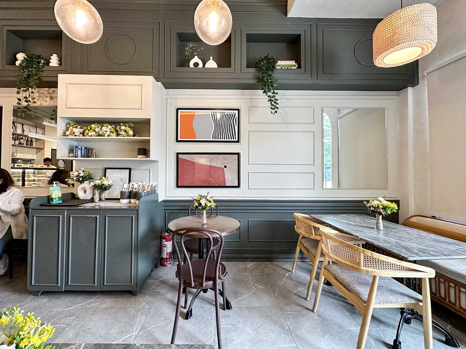 Manila Baker — elegant interior corner with sage cabinetry and gold shelving